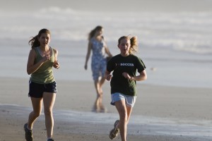 Two girls jogging on the beach